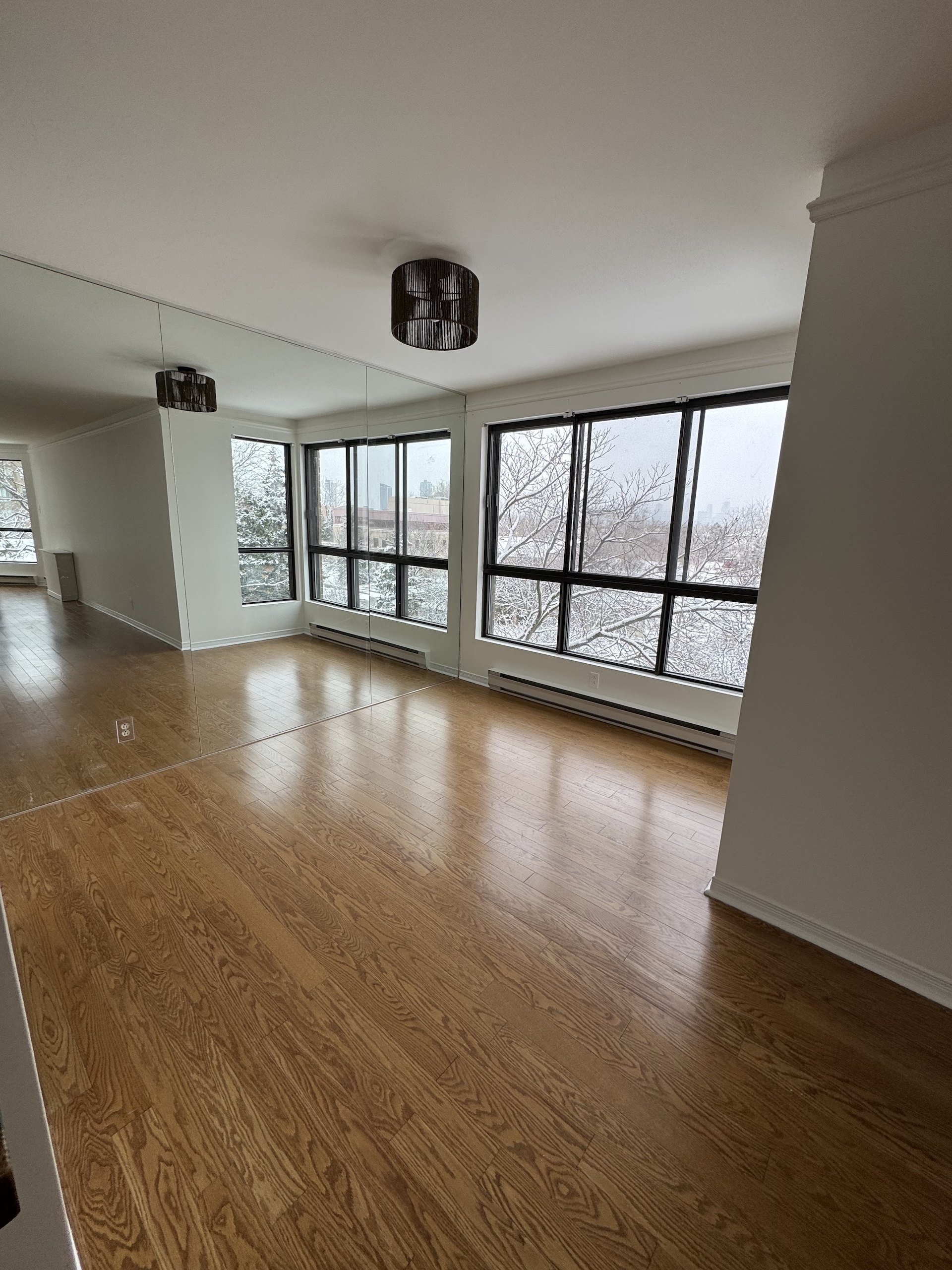 Engineered wood flooring installation in a Montreal condo with floor-to-ceiling windows